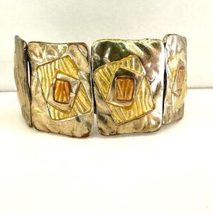 Silver and gold tone hinged bangle bracelet
